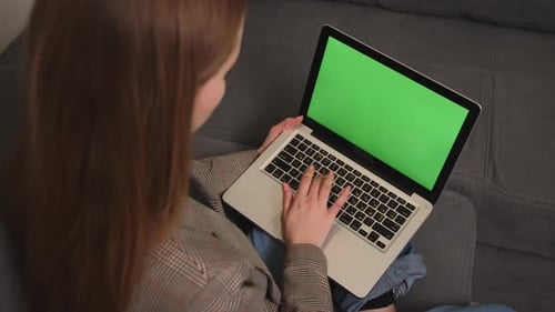 Businesswoman Working on Laptop Green Screen Chromakey on Sofa at Home