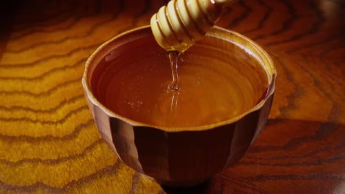 Golden Honey in Wooden Bowl with Dipper