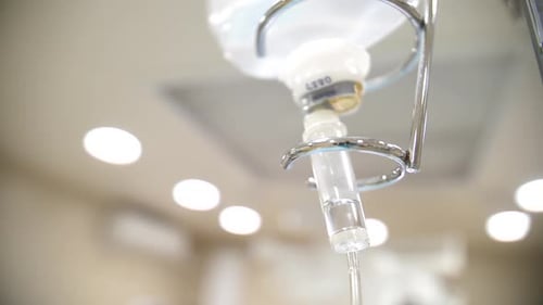 Intravenous Fluid Dripping from IV Bag in Hospital