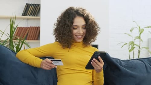 Woman Shopping Online with Phone and Credit Card