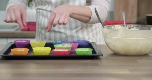 Womans Hands with Cookie Cutters with Muffin Dough