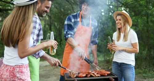 Friends Enjoying a Barbecue Outdoors in Summer