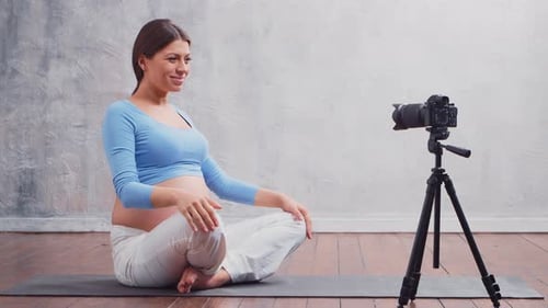 Pregnant Woman Practices Yoga in Front of Camera