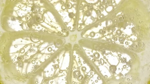 Close Up Lemon Slice in Bubbling Soda Water