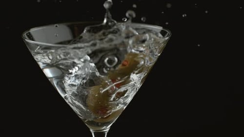 Olives Dropping Into Martini Glass with a Splash