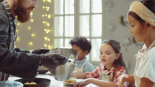 Chef Adding Whipped Cream to Waffles for Kids on Cooking Masterclass