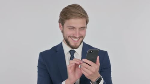 Man in Suit Celebrates Good News on Phone