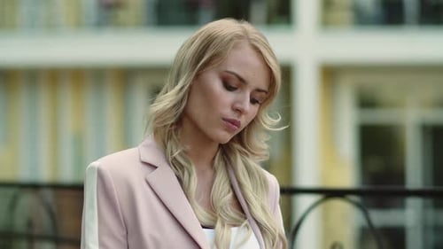 Blonde Woman Puts In Wireless Earbuds