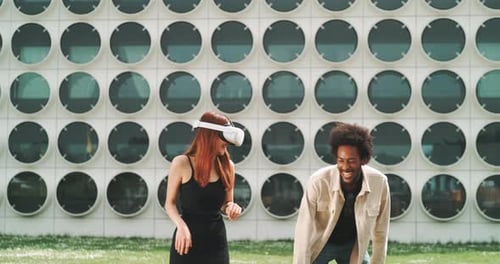 Stylish couple having fun with vr goggles in the city