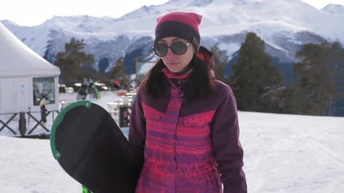 Mädchen Snowboarderin mit Snowboard auf Berggipfel im Skigebiet, Wintersport und Winterurlaub