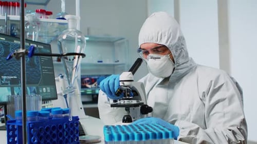 Scientist Examining Samples Under a Microscope in Lab