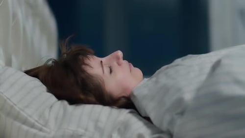 Woman Sleeping Peacefully in Hospital Bed