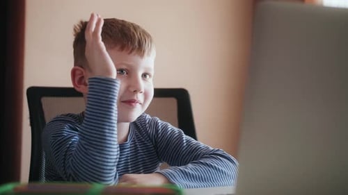 Child Looking at Laptop in Home Office