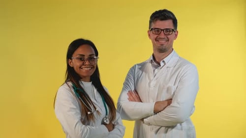 Smiling Doctors Portrait Wearing Lab Coats in Studio