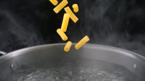 Pasta Falling Into Pot of Boiling Water
