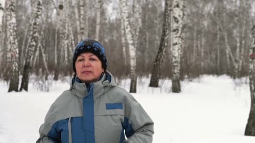 Adult Woman Is Running Through The Forest In Winter