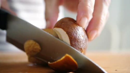 Mushroom Being Sliced on Cutting Board Close Up