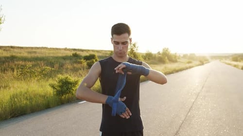 Kickboxer Wrapping Hands Into Tapes Kicking Fists Before Workout Outdoor