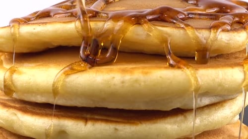 Maple Syrup Poured Over Stack of Pancakes