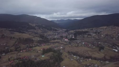 Flight Over the Village in the Carpathian Mountains