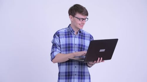 Young Adult Man Typing on Laptop Computer