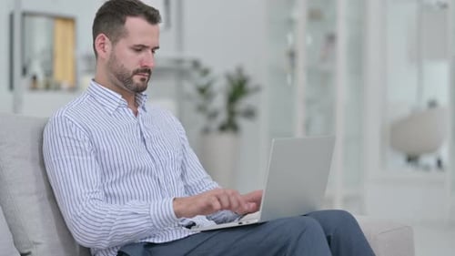 Man Typing on Laptop Having Neck Pain