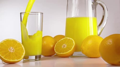 Fresh Orange Juice Pouring Into Glass