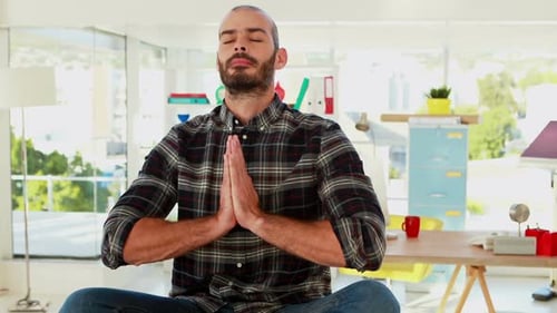 Male executive doing yoga in office 4k