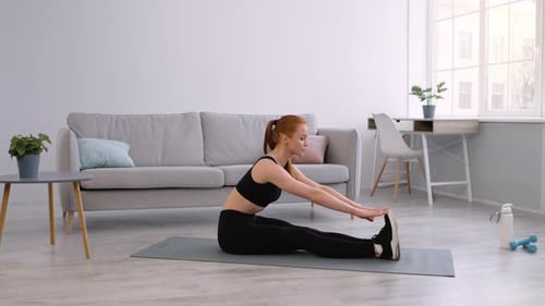 Woman Stretching on Mat in Bright Living Room