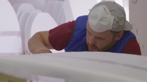 Male surfboard maker in his workshop
