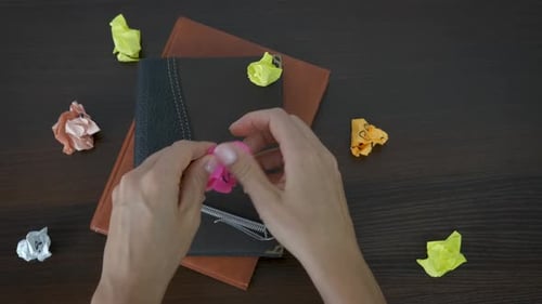 Hands Reveal Inspirational Message on Crumpled Pink Paper
