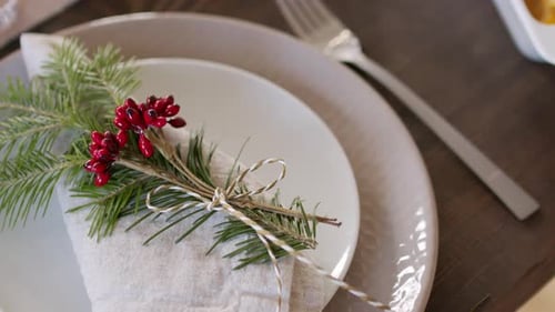 Holiday Table Setting with Pine and Red Berries