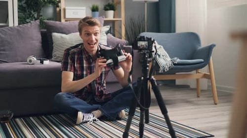 Man Reviews VR Headset on Camera in Living Room
