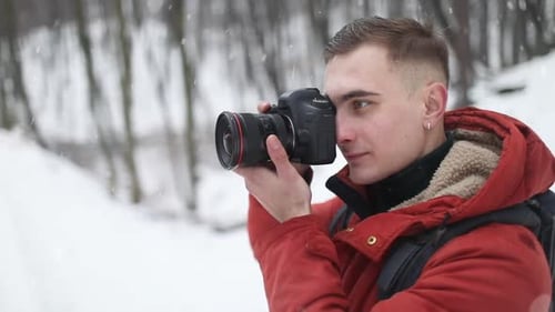 Man Taking Photo with Camera in Forest