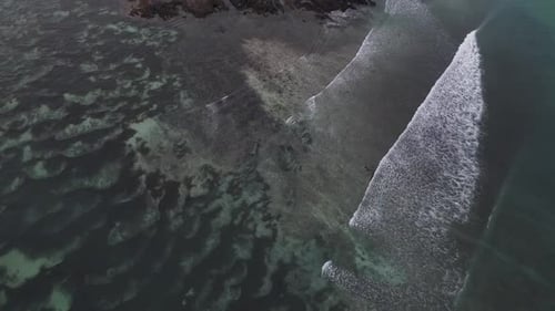Aerial View of Tropical Coastline with Waves