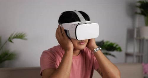 Young Adult Using Virtual Reality Headset at Home