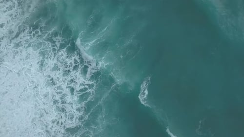 Aerial Top View Turquoise Sea Waves Break on Empty Sand Beach. Clean Sea Waves From Bird's Eye View