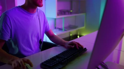 Young Adult Gamer Playing Video Game at Night