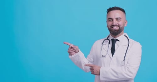Smiling Doctor Points to Copy Space on Blue
