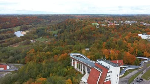 Aerial View of the Bobsleigh and Skeleton Track Luge Track Sigulda Surrounded by Colorful Forests 4K
