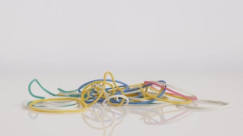 Pile of Colorful Rubber Bands on White Background