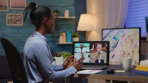 Woman attends virtual meeting on a laptop