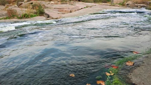 A Small Shining Stream Flows Among Smooth Wet and Dark Stones