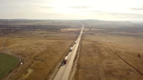 Trucks Traveling on Highway in Rural Setting