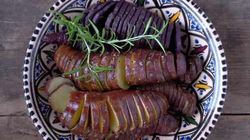 Cooked Potatoes Sliced on a Rustic Plate