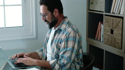 Man Typing on Laptop at Home Office Desk