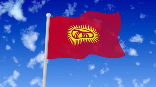 Waving Flag of Kyrgyzstan Against Blue Sky