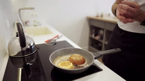 Chef Toasting Burger Buns in Hot Pan