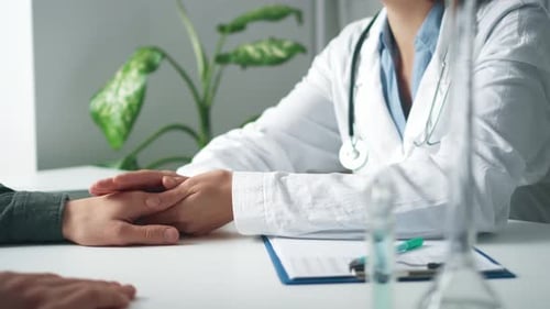 Doctor Holds Patient's Hand in Caring Gesture