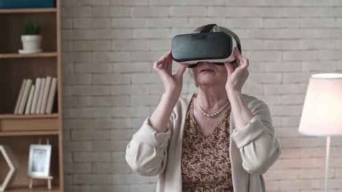 Senior Woman Using Virtual Reality Headset Indoors
